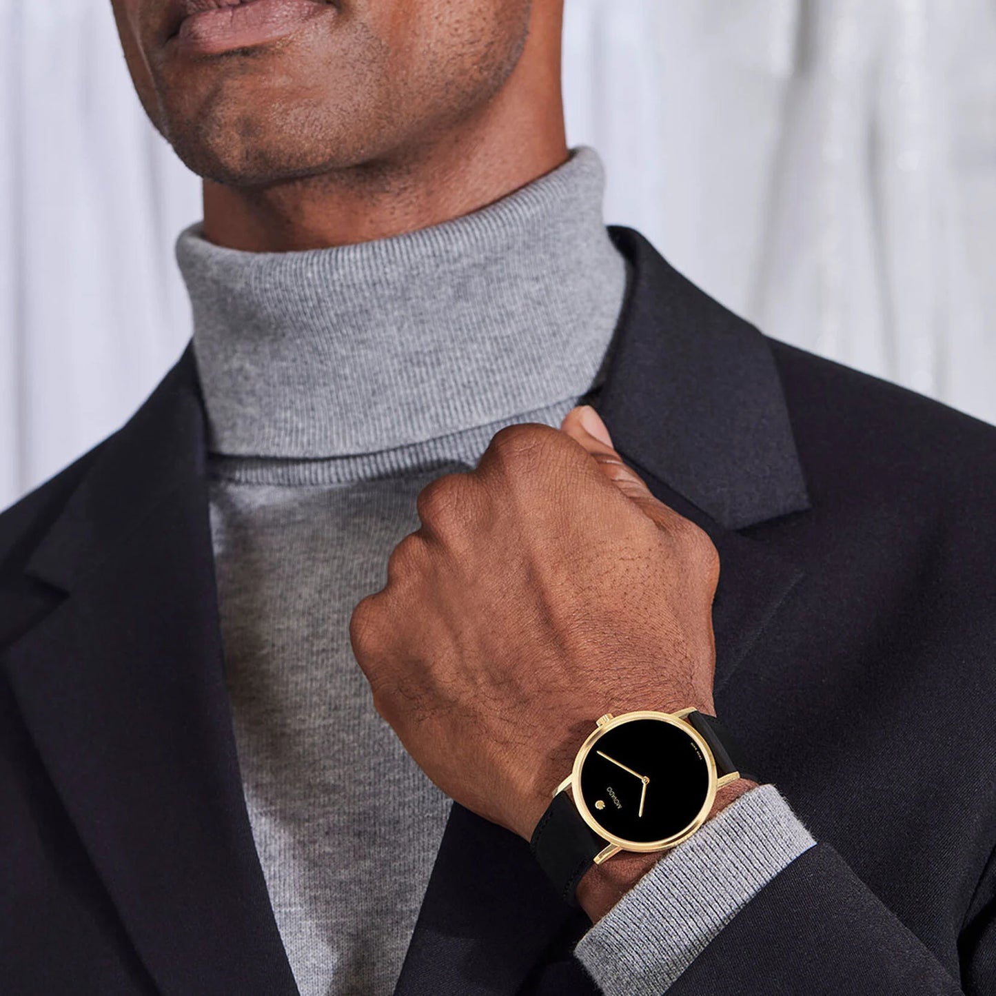 An icon of modern design, the Movado Signature watch features a 40mm yellow gold PVD stainless steel case, a black dial, and a black leather strap