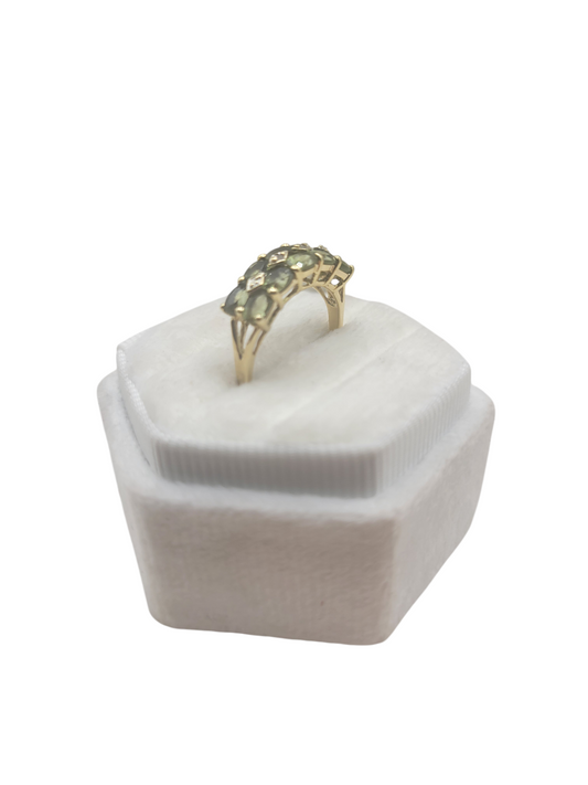 10K gold ring with a chain of green CZ stones. Size 7.
