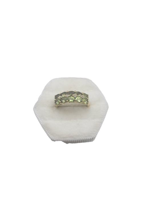 10K gold ring with a chain of green CZ stones. Size 7.