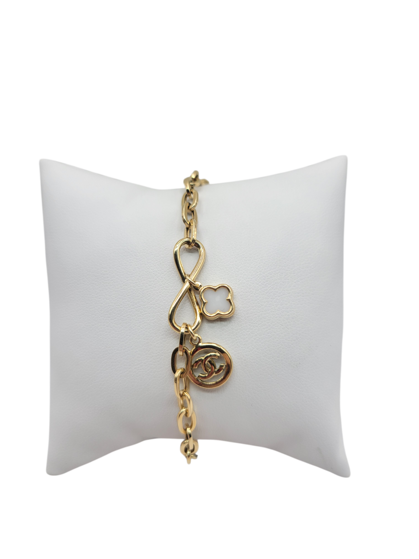 10K gold bracelet with infinity symbol and white flower and CC. 7 inches .5mm